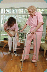 A caregiver helping a client with a walker